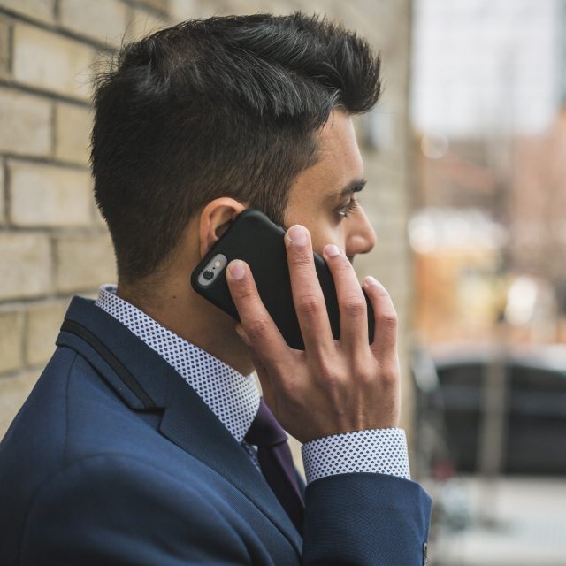 Businessperson in a suit holding a phone